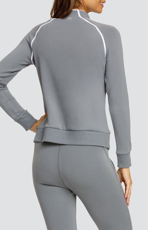 Model wearing a gray long sleeve sweatshirt with a quarter zip neckline, white piping accents, and ribbed hem and cuffs. Paired with a matching jogger with welt pockets.