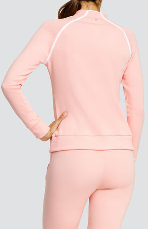 Model wearing a light pink long sleeve sweatshirt with a quarter zip neckline, white piping accents, and ribbed hem and cuffs. Paired with a matching jogger with welt pockets.