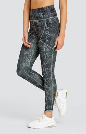 Model wearing hi-rise leggings with pockets in a snakeskin print.