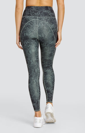 Model wearing hi-rise leggings with pockets in a snakeskin print.