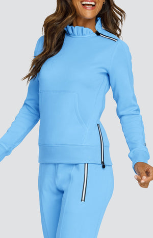 Model is wearing an Ocean Blue pullover with side zipper at the collar and kangaroo pocket. She is wearing matching Ocean Blue joggers. 