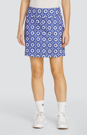 Model wearing a pull-on golf skort with a blue and white geometric pattern.