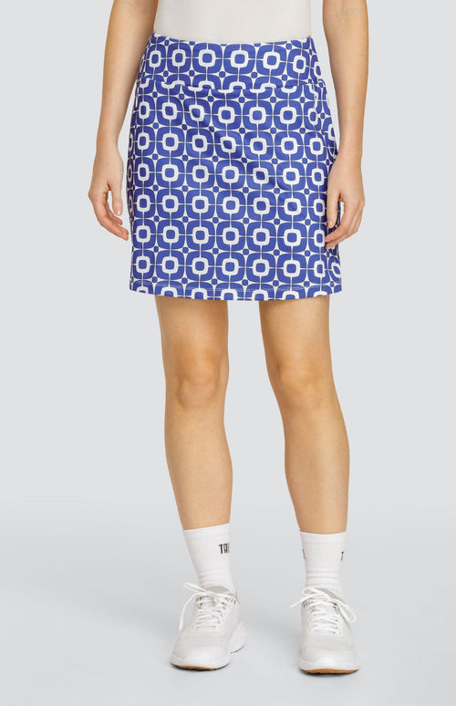 Model wearing a pull-on golf skort with a blue and white geometric pattern.