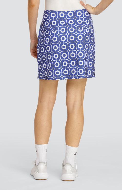 Model wearing a pull-on golf skort with a blue and white geometric pattern.