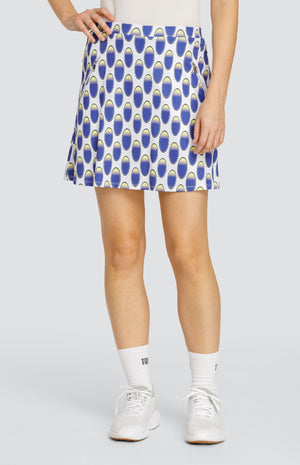 Model wearing a pull-on golf skirt with an oval pattern in blue and yellow on a white background.