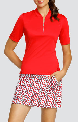 Model wearing a red short sleeve top and a pull-on skort with a geometric red and white print.