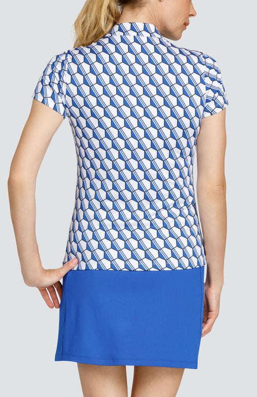 Model wearing a short sleeve top with a blue and white hexagon pattern, and a solid blue skort.