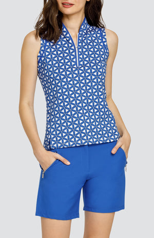 Model wearing a sleeveless top with a blue and white lattice pattern, and blue shorts.