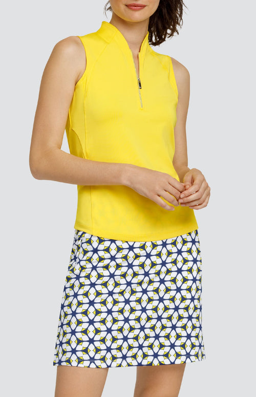 Model wearing a Dandelion yellow sleeveless top in performance jersey fabric with raised collar and curved hem. 