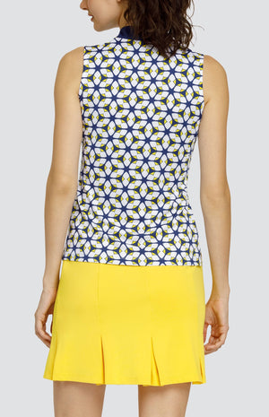 Model is wearing a sleeveless performance jersey top with a novelty collar. The top is in print "Jewel Twist" showing a geometric pattern of Lakestorm blue, Dandelion yellow, and Chalk white. 