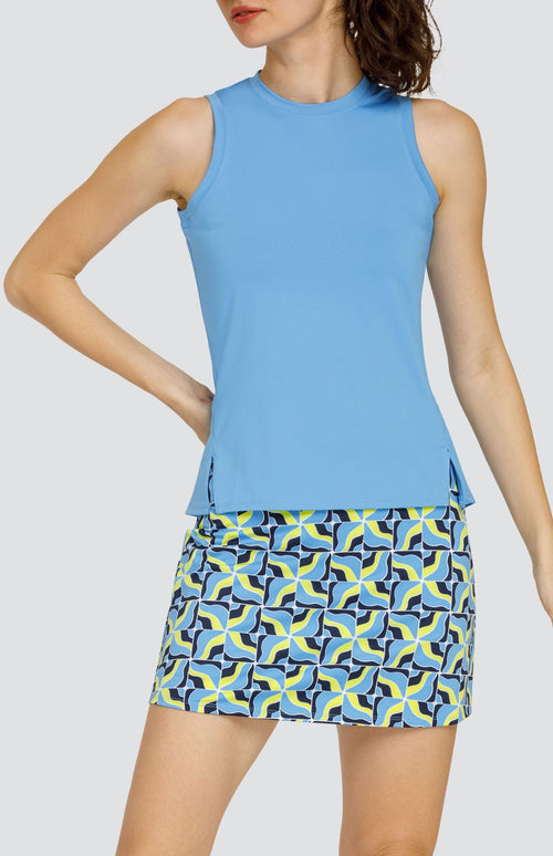 Model wearing a light blue tank top and a skort with light blue and neon yellow abstract grid pattern.