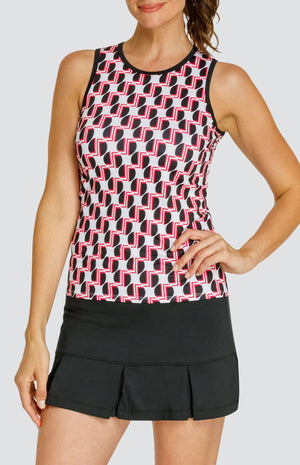 Model wearing a tennis tank with a geometric black and red pattern on a white background, and a black pleated skort.