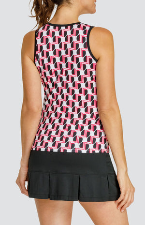 Model wearing a tennis tank with a geometric black and red pattern on a white background, and a black pleated skort.